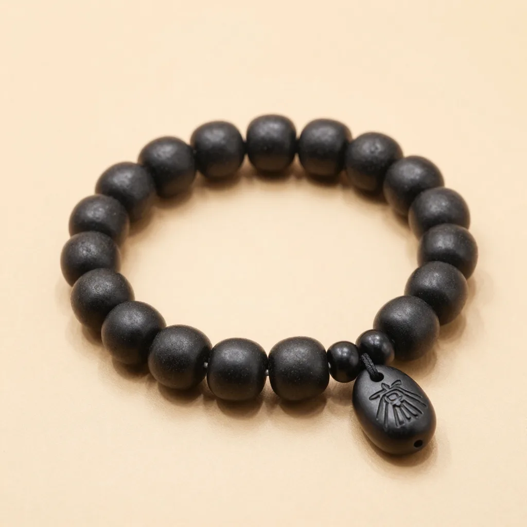 A charcoal tagua bracelet and pendant set on a light background